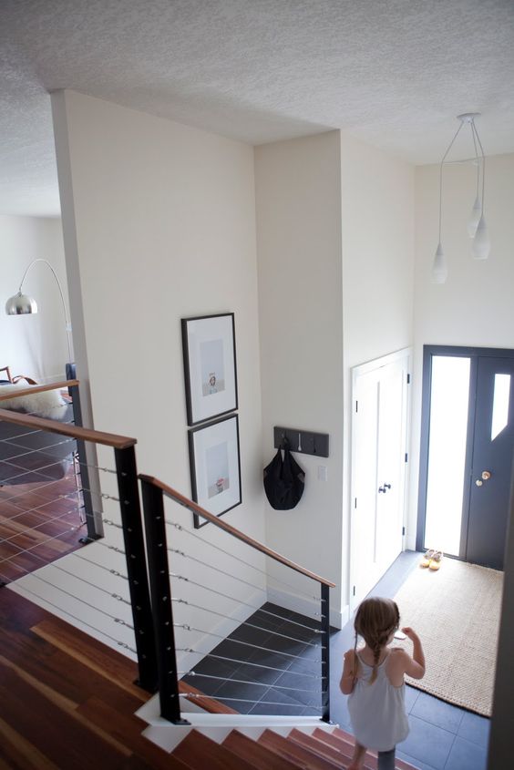 modern wooden staircase with metal posts, wood and cable railing