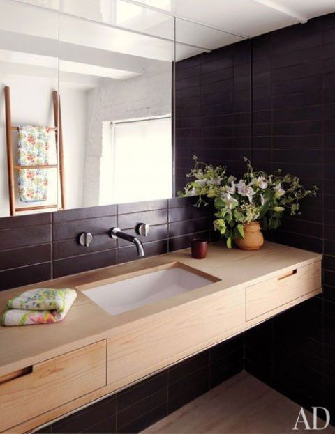 red cedar custom-made vanity with drawers in front of a black wall looks wow