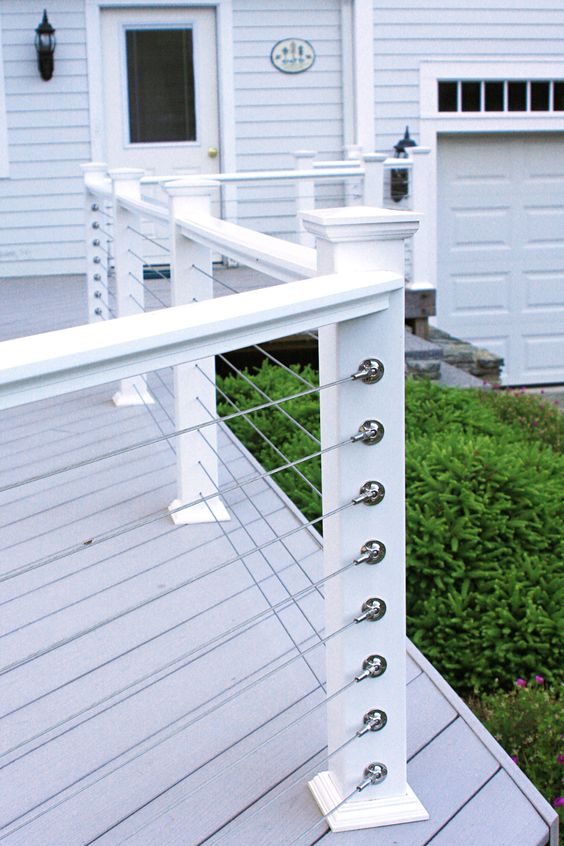 38 simple white posts and horizontal cable railing for a beachside cottage