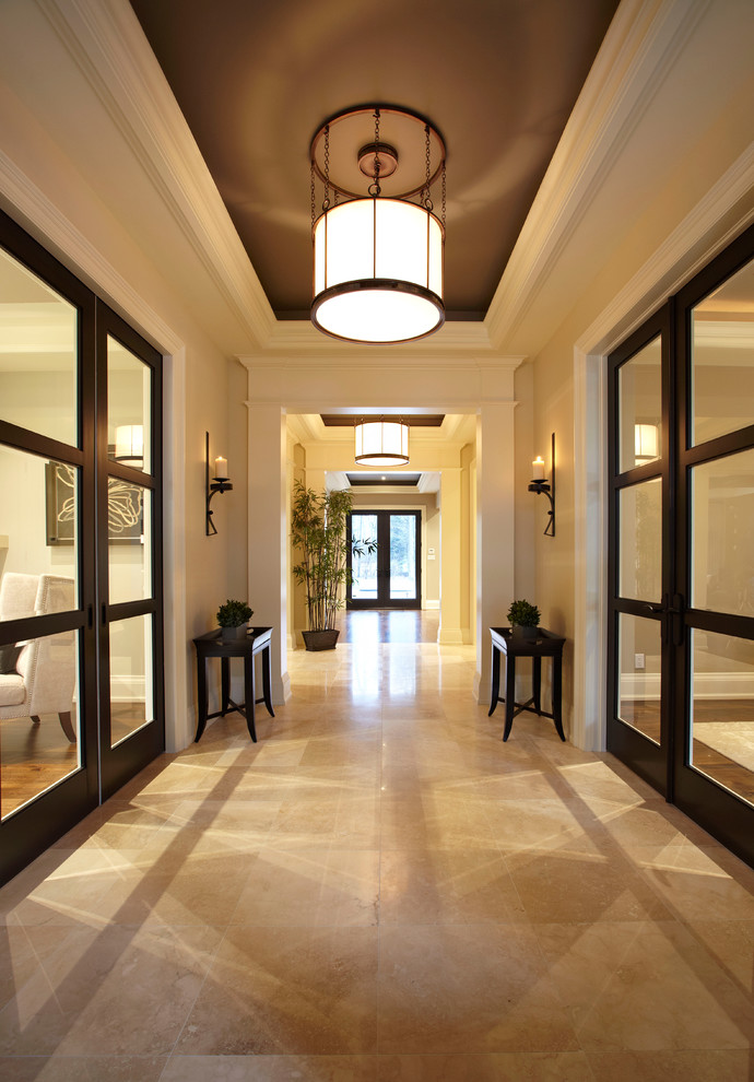 this contemporary entryway features glass paneled sliding doors on both sides allowing light to fill in this welcoming space (Parkyn Design)