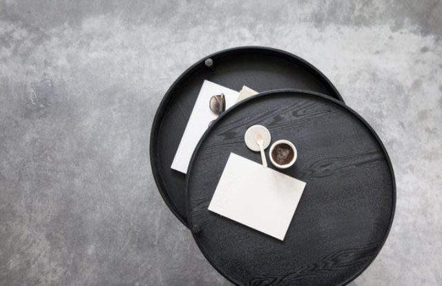 The Turning Table is a low coffee table with an openable lid, which turns around one of three wooden legs