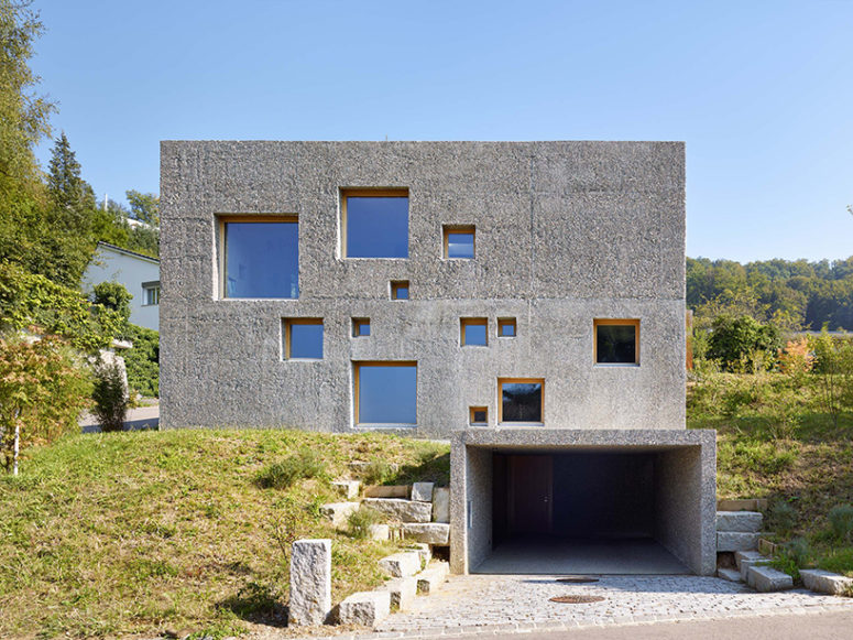 This modern concrete home replaced the previous property and carefully integrated into the landscape