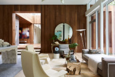 02 A warm-colored wood wall is a partition, and a glazed one connects the living room with outdoors