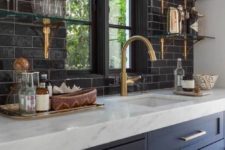 02 navy kitchen cabinets with brass handles and details with white stone countertops