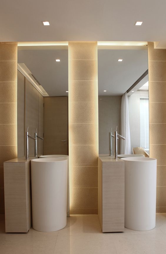 simple round sinks and nickel faucets in a neutral bathroom