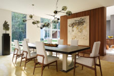 03 The dining space is a comfy one with upholstered chairs and a stunning dark glass chandelier