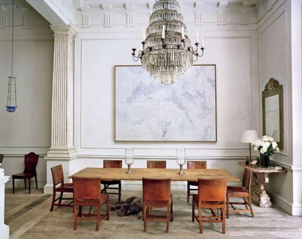 The dining space shows a vintage dining set, a gorgeous vintage glam chandelier and an antique table and mirror