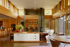03 The kitchen is modern with a mid-century modern feel, done in white and light-colored wood