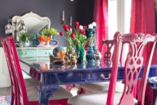 03 a bold blue dining table, hot pink chairs and a crystal chandelier for a vibrant space