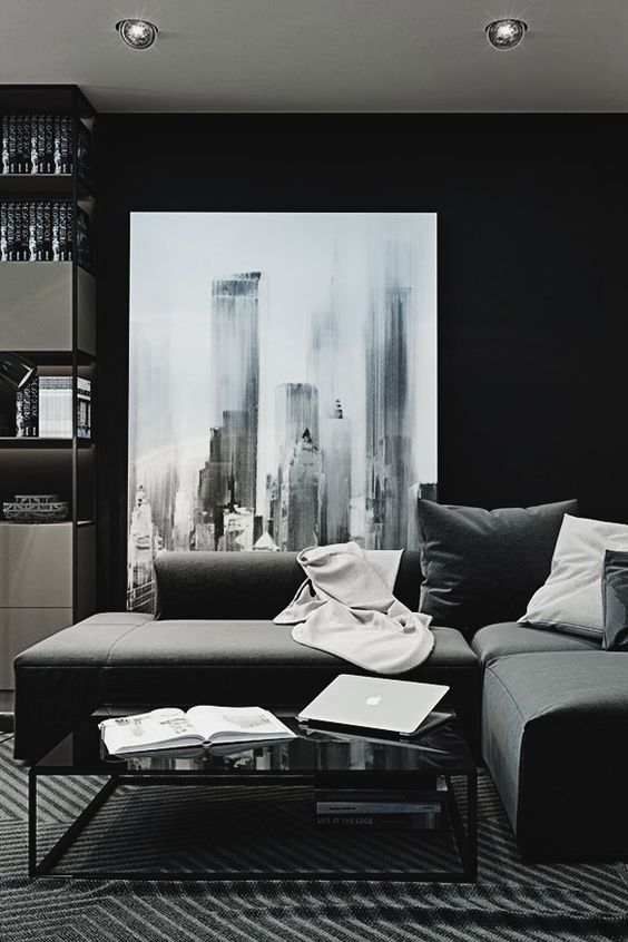 a large dark-colored corner sofa with pillows