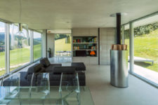 04 The inside of the home is open plan, with lots of modern materials used – metal, glass, acryl