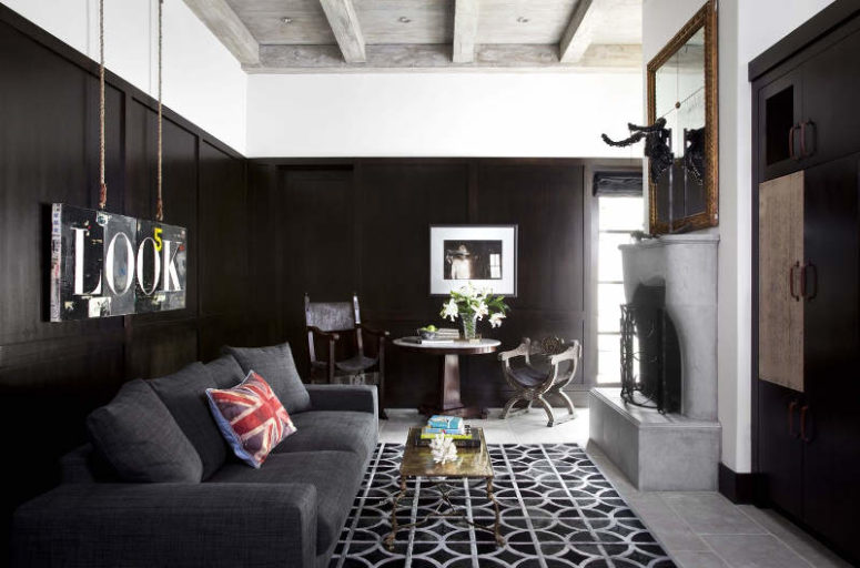 There's a dark room done in black, with a fireplace and an oversized mirror, for a contrast and a soothing ambience