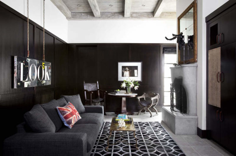 There's a dark room done in black, with a fireplace and an oversized mirror, for a contrast and a soothing ambience There's a dark room done in black, with a fireplace and an oversized mirror, for a contrast and a soothing ambience