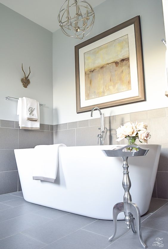 neutral bathroom with metallic touches and a freestanding bathtub looks cool