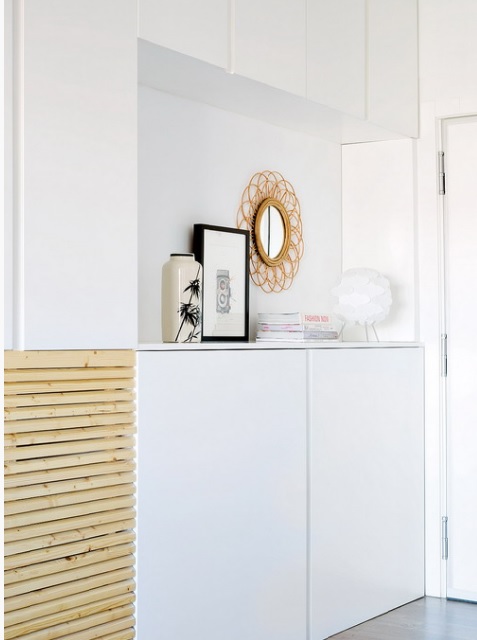 The cabinets are a smart storage that declutter the living room and look sleek