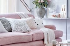 05 a pink upholstered sofa on tall legs looks cool with copper details