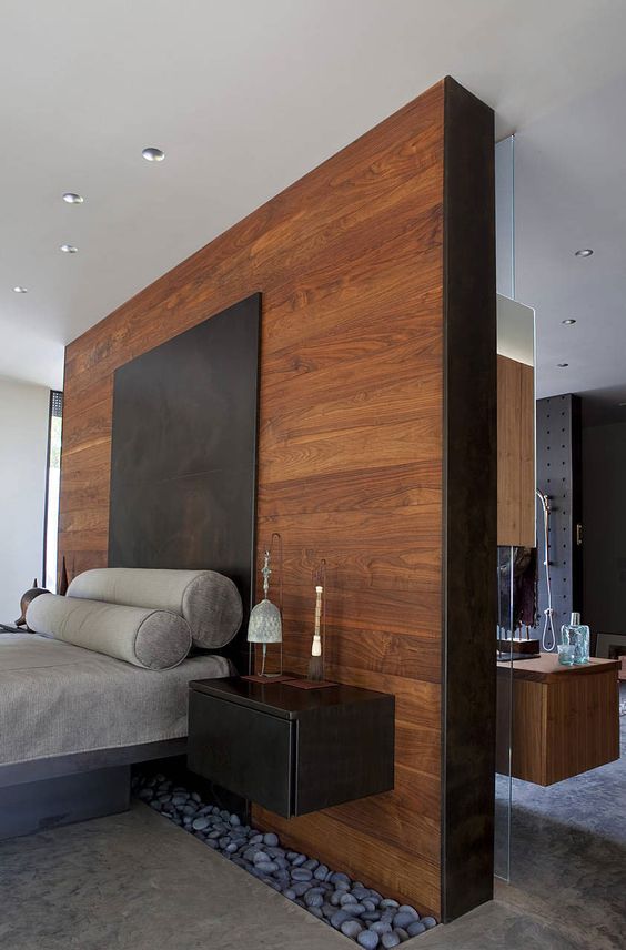 grey platform bed with an oversized black headboard