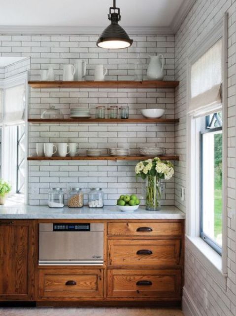 white subway tiles and warm wood shelves in front of a white wall