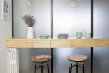 08 There’s a breakfast nook with a wooden countertop and bulbs over the it for more light