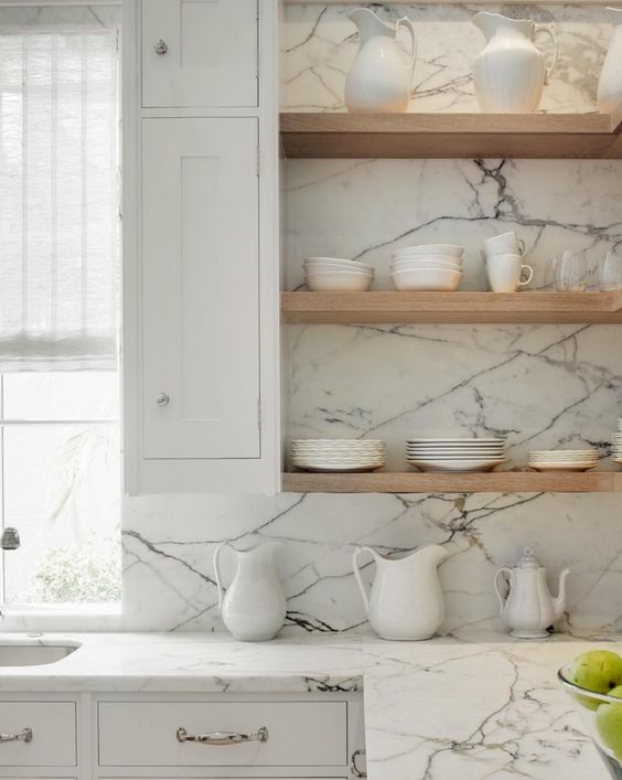 stone slab counters and light-colored wooden shelves for a modern fresh look