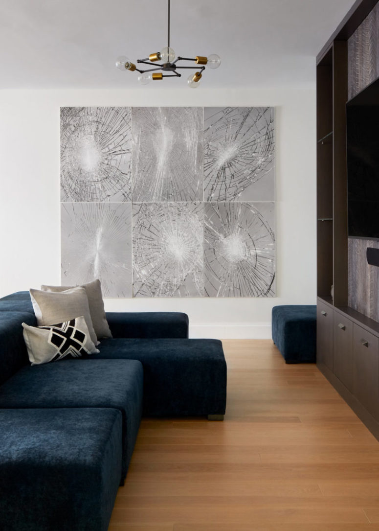 The crcked glass artworks make a bold statement in this space and remind that this is a bachelor's apartment The crcked glass artworks make a bold statement in this space and remind that this is a bachelor's apartment