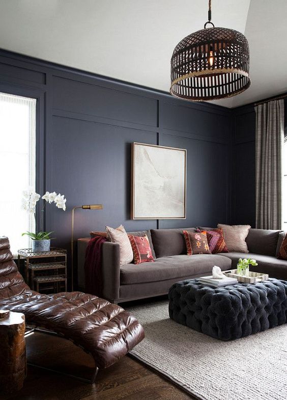 a brown uphosltered sofa, a leather lounger and a dark grey ottoman