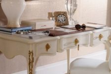 10 a refined white desk with gold details and a matching chair