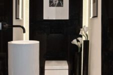 10 white free-standing sink in a black and white bathroom