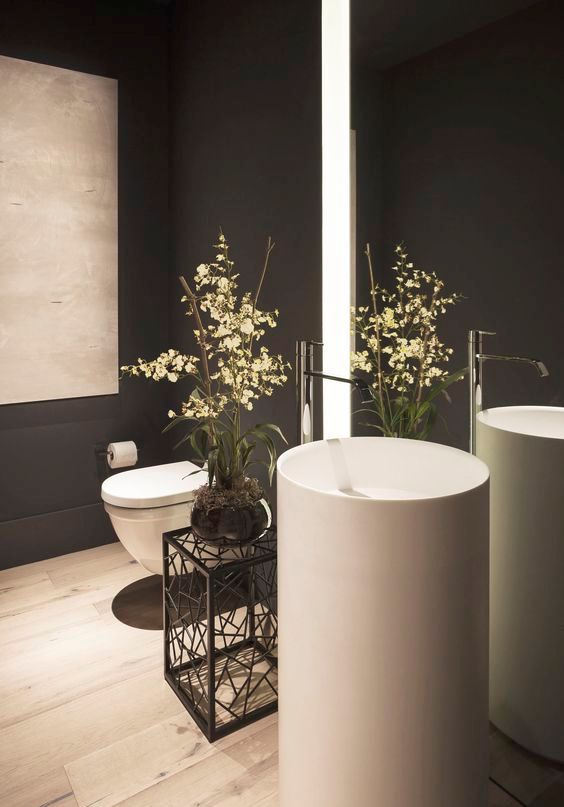 gorgeous round free-standing sink in a black bathroom