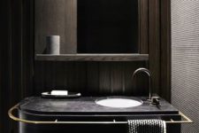 13 a black marble vanity with a towel holder along it