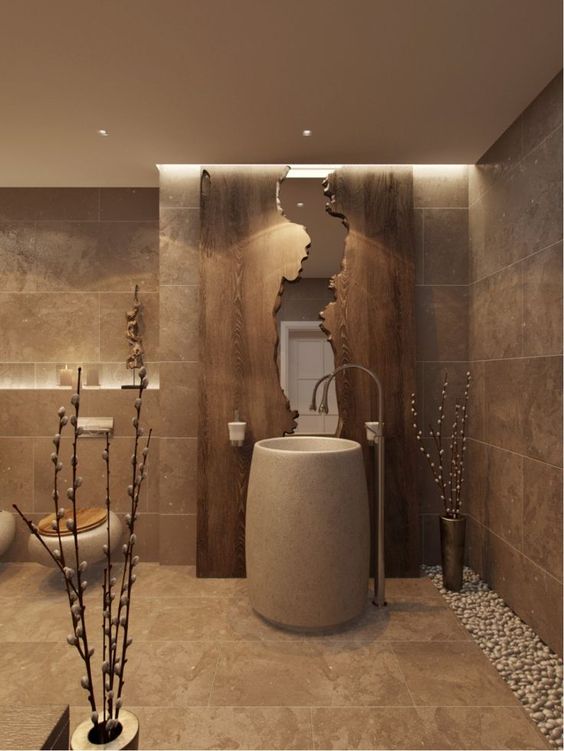 a stone sink, a wooden wall with a mirror inside add texture and luxury to the bathroom