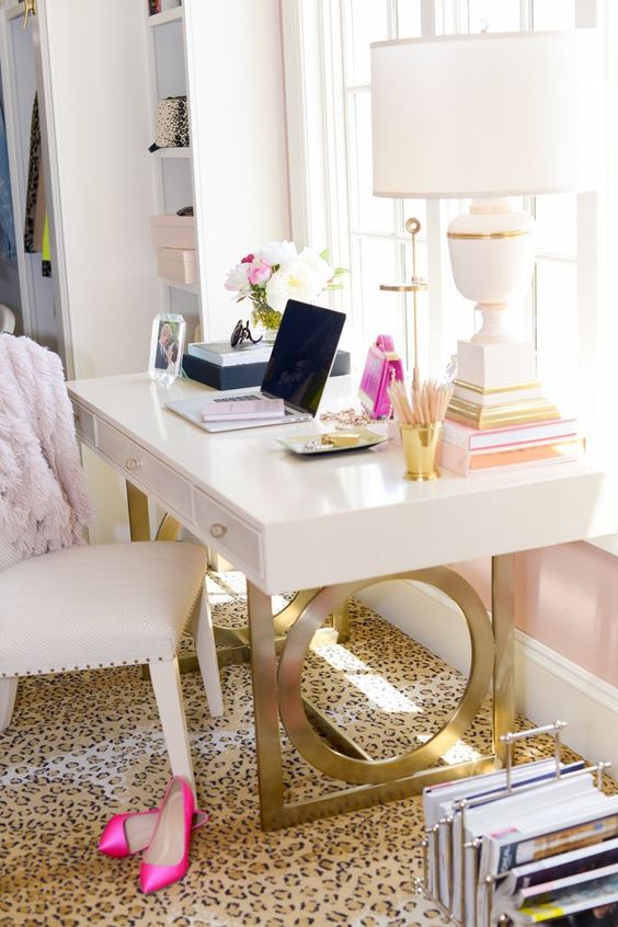 a white desk on gold sculptural legs for a glam feel