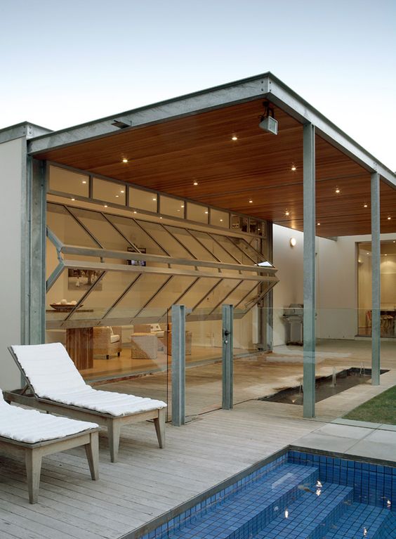 bi-fold garage doors open the living room to the outdoor spaces