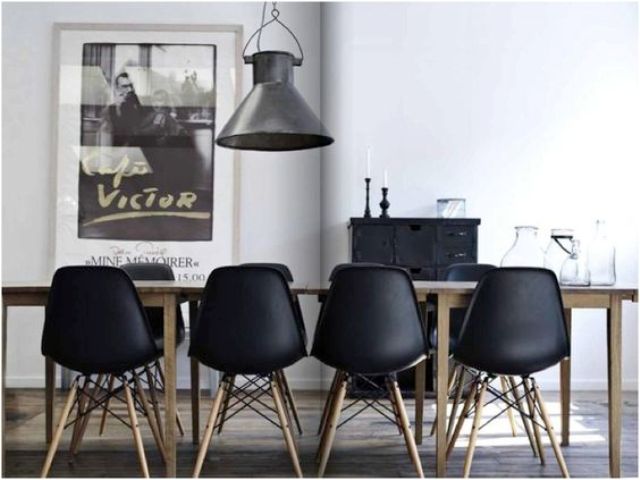 modern black chairs accentuate a light-colored wooden table