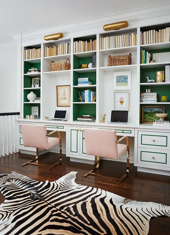 a white and emerald storage system with built-in desks for a shared office