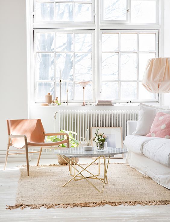lightweight looking coffee table with gold thin legs and a marble top