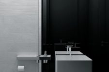 23 a minimalist black and white bathroom with a square sink