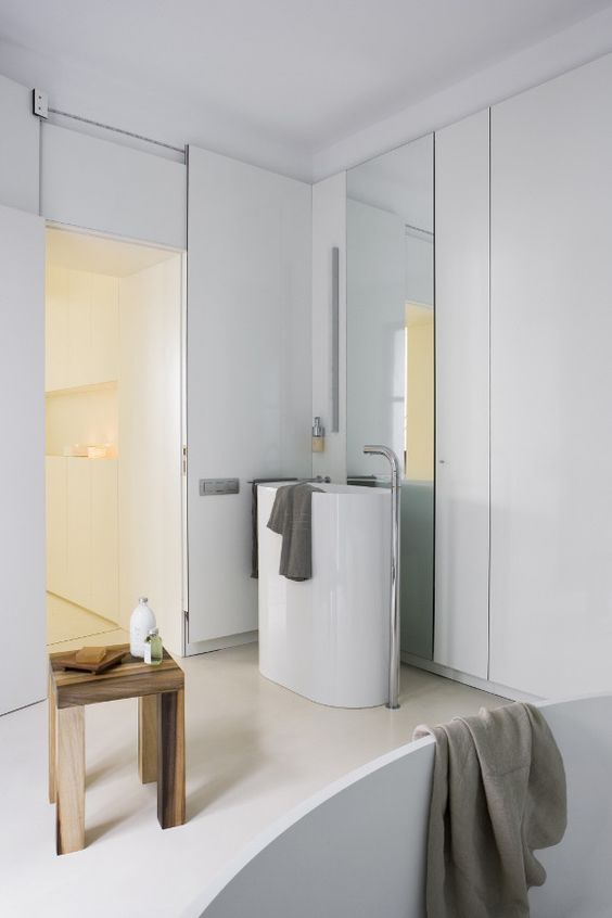 a modern serene bathroom with an oval free-standing sink