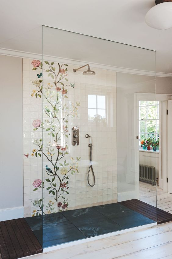 a walk-in shower with floral tiles looks girlish