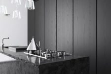 24 black stone kitchen island is a textural touch for a sleek minimalist kitchen