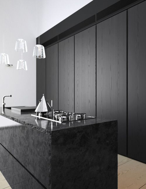 black stone kitchen island is a textural touch for a sleek minimalist kitchen