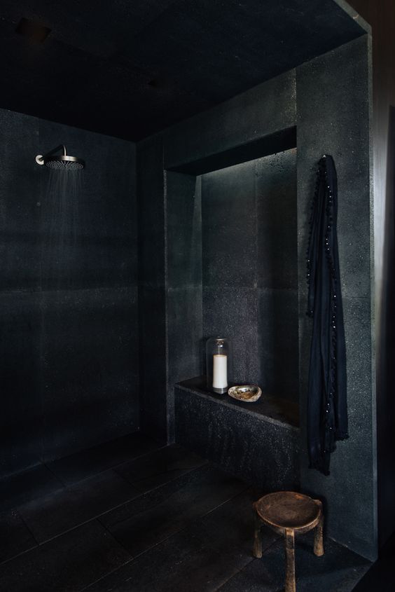 dramatic dark concrete shower with a niche for storage is a very manly idea