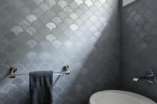 27 a white asymmetrical sink refreshes the moody grey fish scale tiles