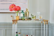 27 lucite bar cart with gilded elements looks super elegant