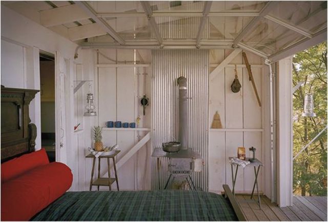 tiny cabin bedroom with a roll up garage door to feel almost outside