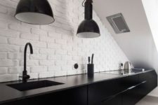 28 oversized industrial black pendant lamps in a black and white kitchen