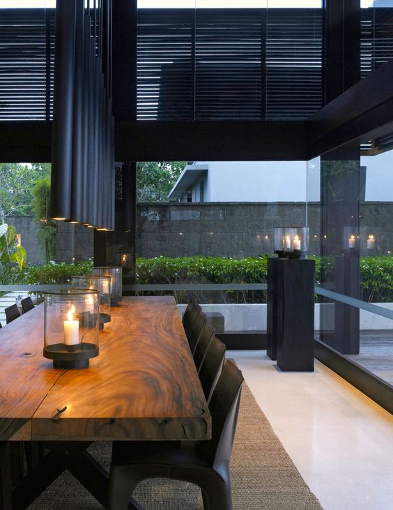 tube-like matte black pendants make the dining space manly