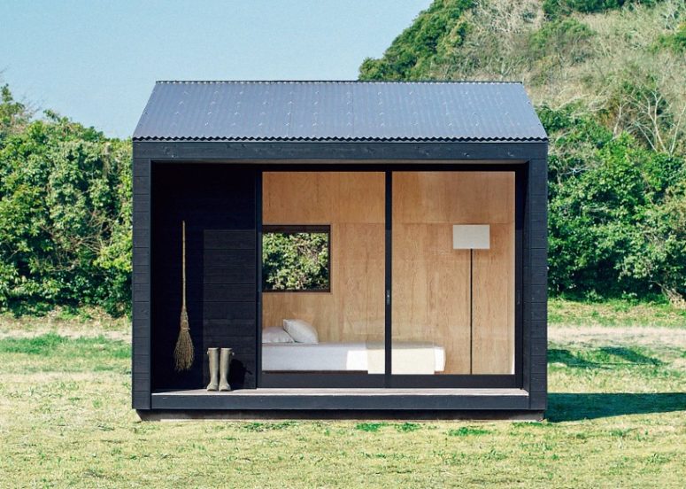 The hut is covered with cedar wood, and it's black outside because it catches more sunlight and it's warmer inside