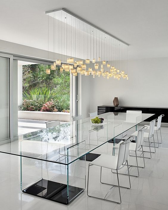transparent glass table with glass legs and black bases