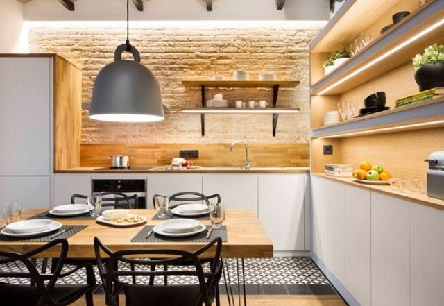 brick wall on a kitchen The exposed brick wall and lit up shelves look great together and a play of textures is adorable